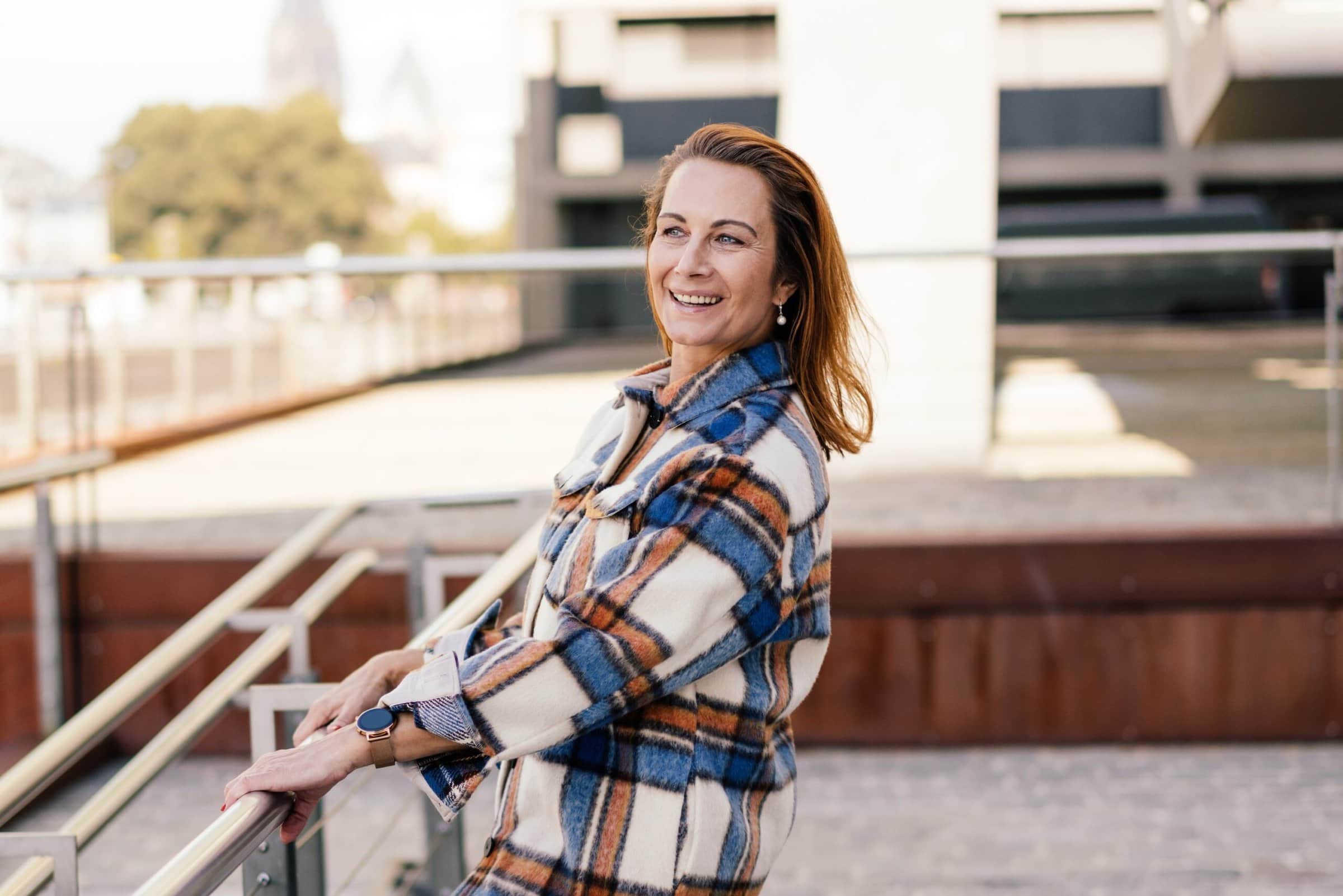 Happy,Carefree,Lady,With,A,Vivacious,Happy,Smile,Leaning,Back